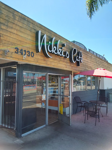 Nikki's Café hand-lettered sign on the storefront